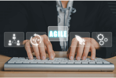 Agile development concept with hands typing on a keyboard and digital workflow icons overlay.