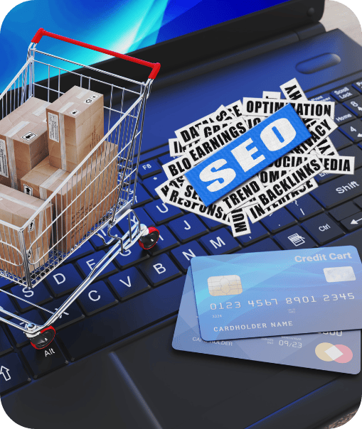 A miniature shopping cart with boxes, SEO text, and credit cards is placed on a laptop keyboard.