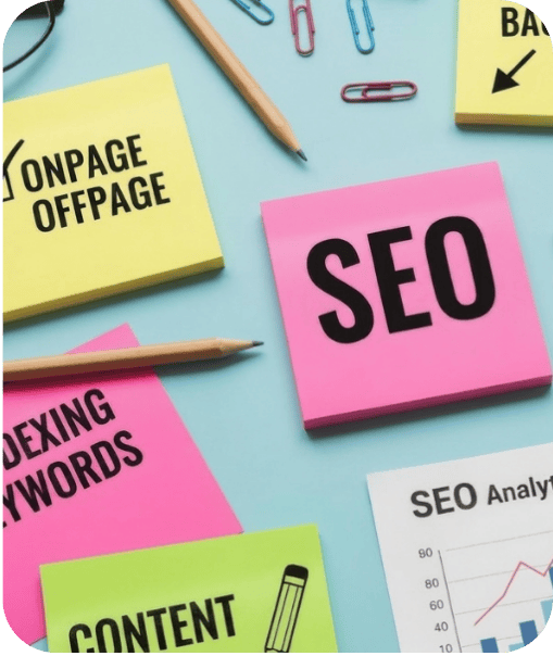 Sticky notes with SEO-related terms like "ONPAGE OFFPAGE," "INDEXING KEYWORDS," "CONTENT," and "SEO," along with pencils and paper clips on a light blue surface.