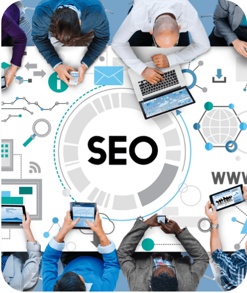 People sitting around a table working on laptops and tablets with a large "SEO" graphic in the center.