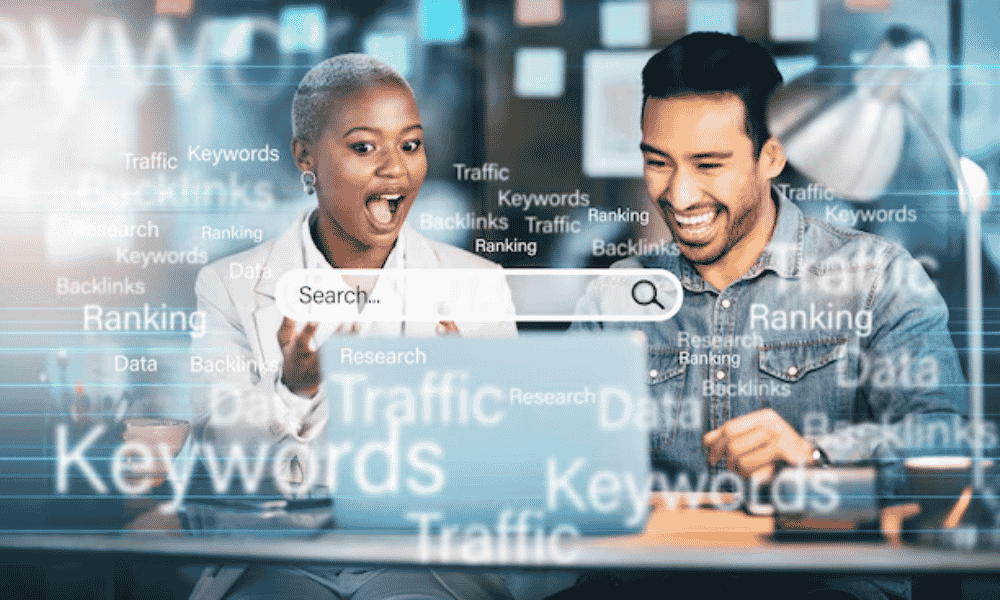 Laptop and smartphone on a white desk surrounded by SEO-related keywords.