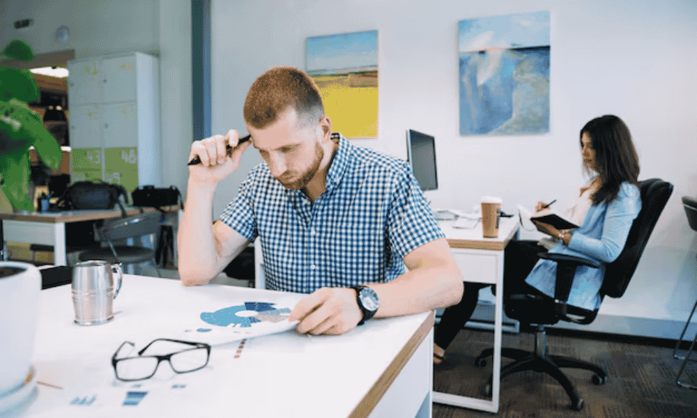a man in office thinking and working