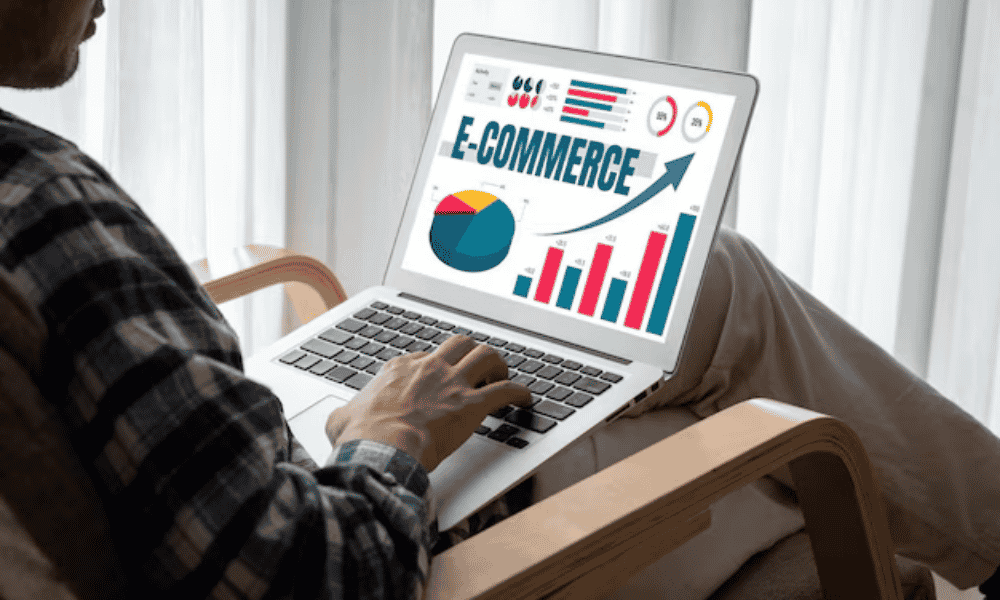 A man using laptop and graph and E-Commerce is shown on the screen and finding about SEO for online businesses