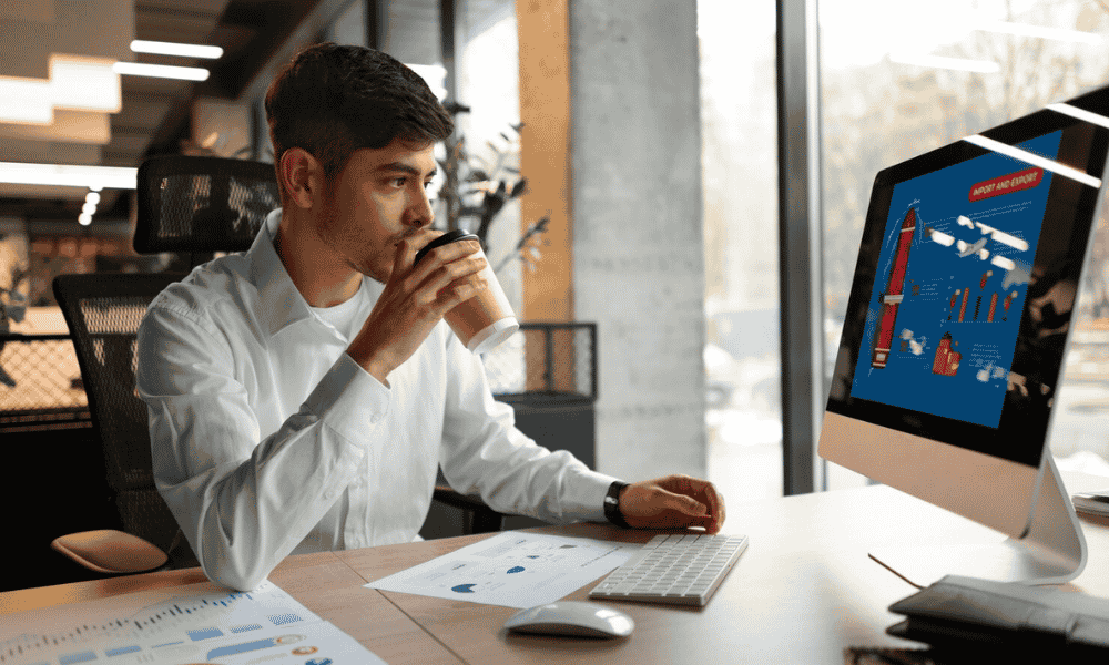 a young mam working on computer and taking coffee, Search Engine Optimization Business