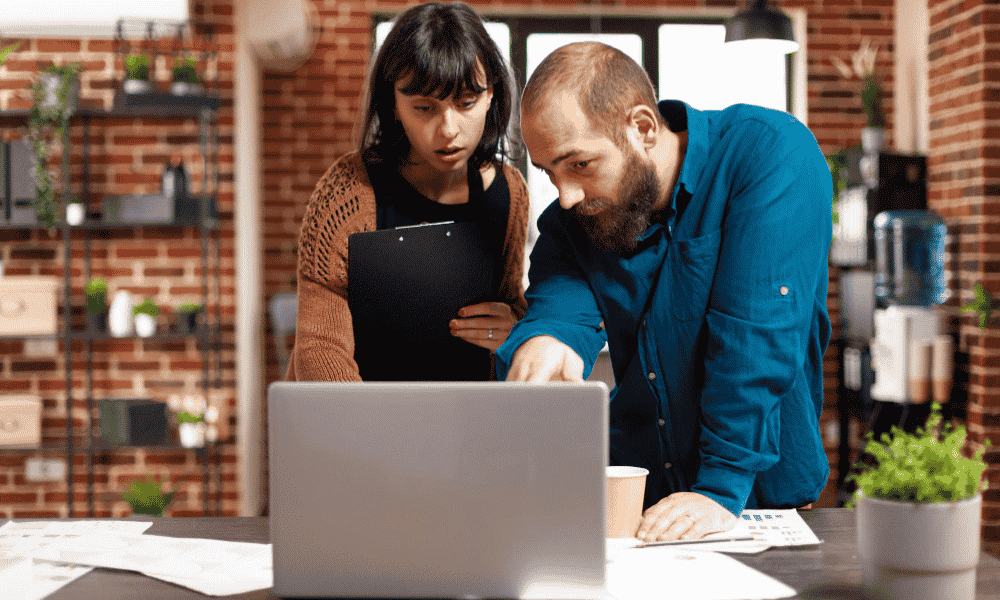 man and woman searching and finding something on computer