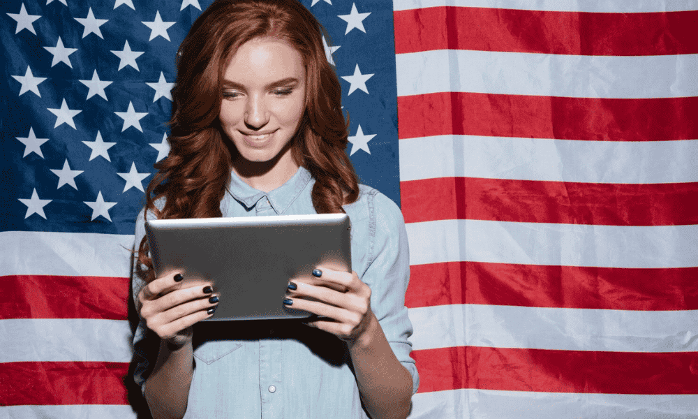 a female holding tablet and looking at it
